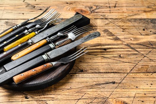 Rustic set of cutlery knife and fork. Wooden background. Top view. Copy space.