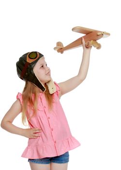 Little girl with a plane in her hand. The concept of a dream of long journeys. Isolated on white background.