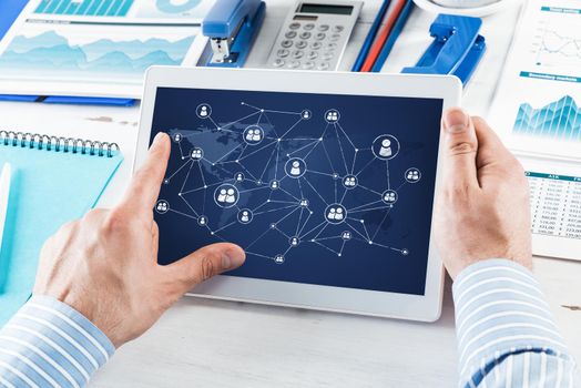 Men's hands hold a computer tablet. Social media concept