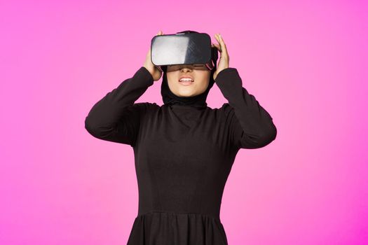 woman in black hijab glasses virtual reality technology movie watching. High quality photo