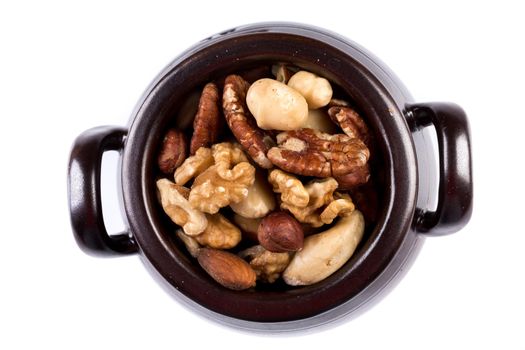 Large diversity of healthy nuts in a dark bowl - isolated