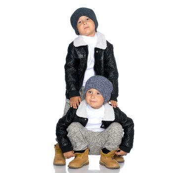 Studio portrait of boys in black leather jackets.Isolated on white background.