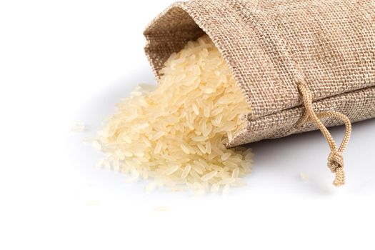 Rice in a sack and spilled on a white background