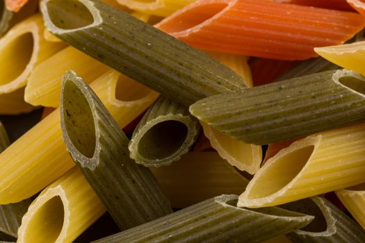 Color penne pasta. Tomato, spinach and wheat pastas in horizontal format