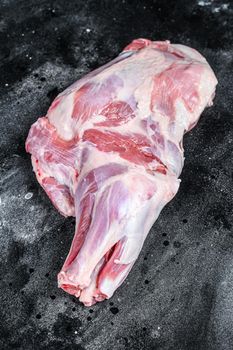 Raw lamb shoulder meat. Black background. Top view.