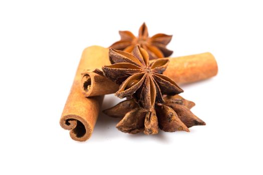 Stars of anise and cinnamon on white background