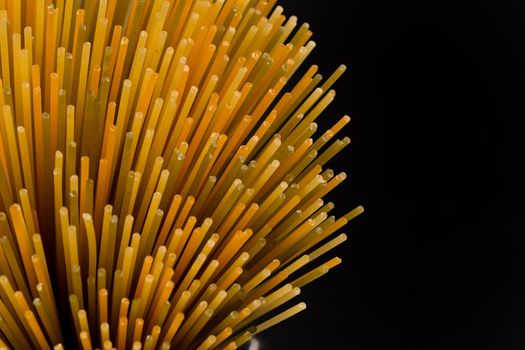 Bunch of raw italian pasta with vegetable dye of spinach, paprika and carrot