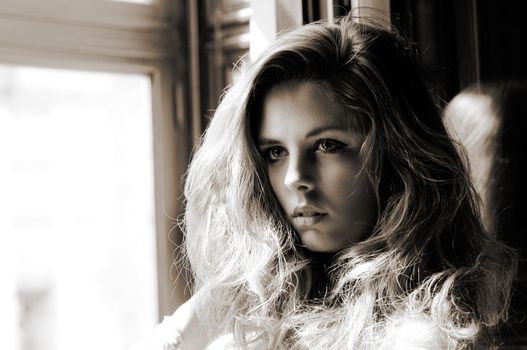 Portrait of a sexy blonde woman, model of fashion, in window