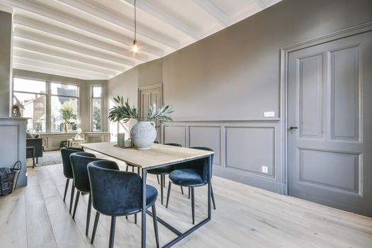 Bright dining room with blue velvet table and chairs