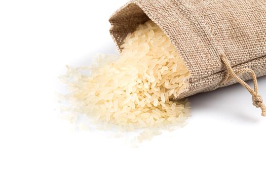 Rice in a sack and spilled on a white background