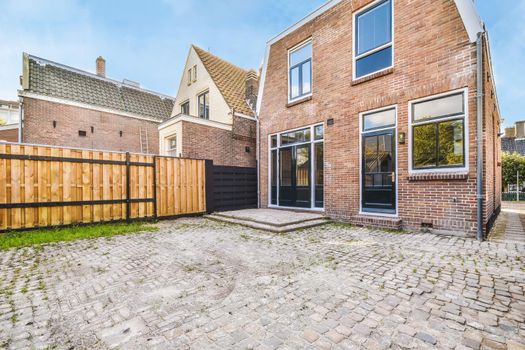 Delightful backyard of the brick house with big windows