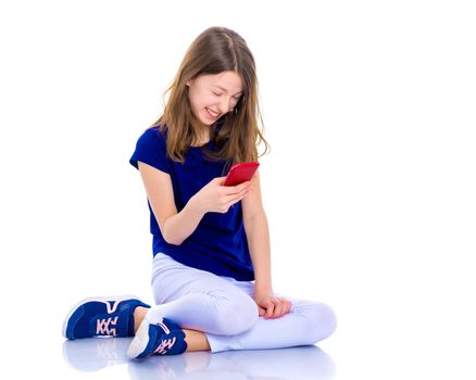 Happy little girl enjoys a smartphone. The concept of people and technology. Isolated on white background.