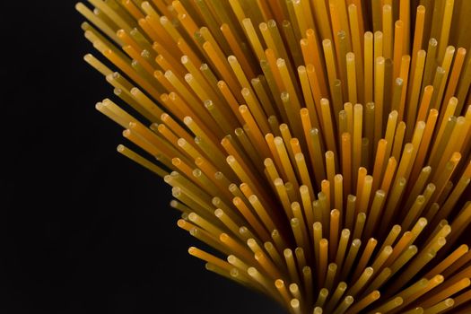 Bunch of raw italian pasta with vegetable dye of spinach, paprika and carrot