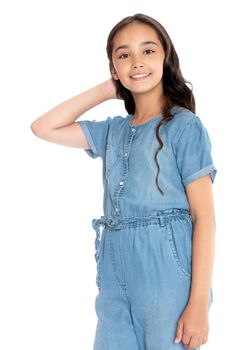Fashionable teenager girl in denim overalls . Long dark hair down to her shoulders. Close-up-Isolated on white background