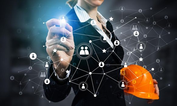 Businesswoman pointing on abstract 3d network. Back view of woman engineer in business suit and safety helmet. Social connection and networking. Futuristic technology concept with 3d plexus structure.