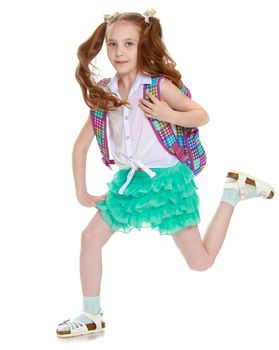 Cute little girl in a short green skirt and white shirt with a backpack on their shoulders to hurry to school-Isolated on white background