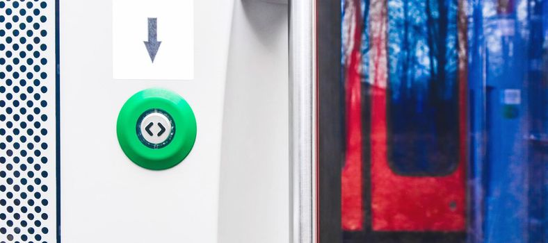 Button opening the door of a modern electric train stadler, close up.