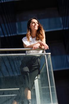 Caucasian female entrepreneur in formal clothes. Confident businesswoman standing outside an office building.