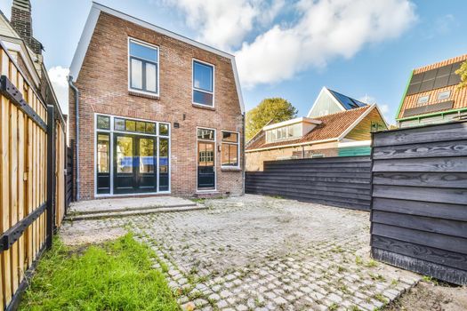 Delightful backyard of the brick house with big windows