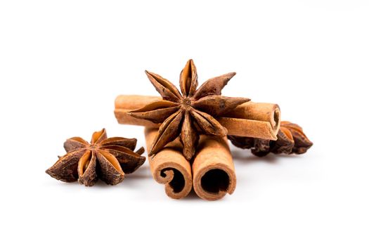 Stars of anise and cinnamon on white background