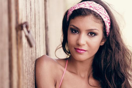Portrait of a beautiful mixed woman with pink hair scarf