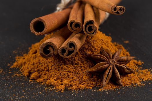 Anise and cinnamon close up on dark stone