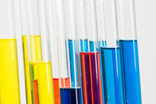 Organic chemistry laboratory analysis and testing. Group of samples in test tubes on white background. Scientific technology concept with glassware equipment. Pharmaceutical industry research.