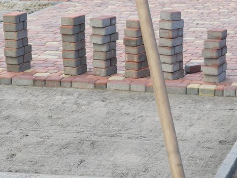 laying paving slabs on city square, repairing sidewalk