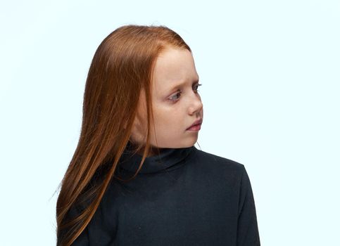 red-haired girl in a black sweater planning close-up. High quality photo