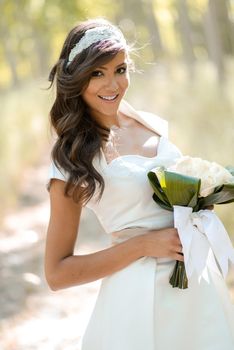 Portrait of beautiful bride outdoors in a forest