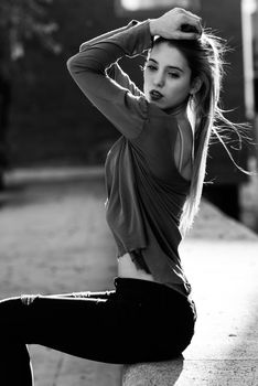 Portrait of happy blonde girl wearing casual clothes, in urban background