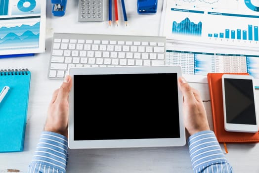 close-up of men's hands with a computer tablet. Businessman works in the office