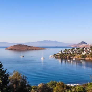 Aegean coast with marvelous blue water, rich nature, islands, mountains and small white houses