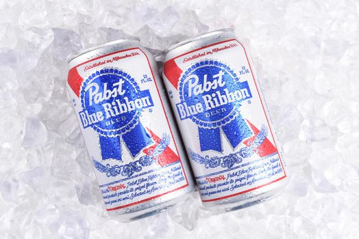 IRVINE, CALIFORNIA - MARCH 16, 2017: Pabst Blue Ribbon Beer. Two cans of the American brand on a bed of ice, introduced in 1884 in Milwaukee, currently based in Los Angeles.