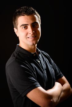 Portrait of a young casual man on black background