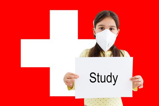 little girl in mask looks at the camera on the background of the Switzerland flag. Health care and medical concept. Surgery concept and fight the virus in Switzerland.