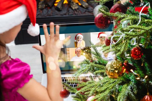 Attractive happy young girl student having video chat, waving. christmas.