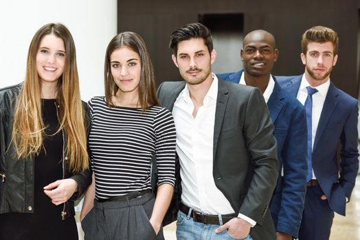 Multi-ethnic and confident business team standing in an office building