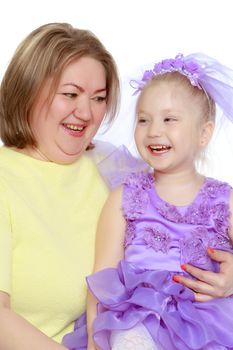 Young blonde mother, gently hugs her favorite little round-faced daughter. Family Idyll.Isolated on white background.