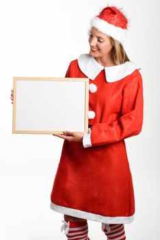 Beautiful happy blonde woman in Santa Claus clothes smiling with white board in her hands. Young female with blue eyes, isolated on white