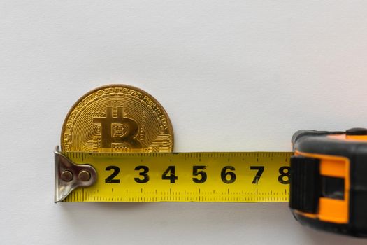 golden crypto coin in tape measure. High quality photo