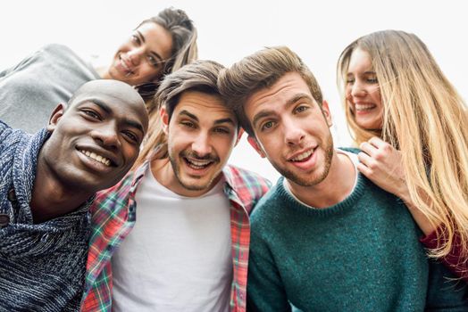 Multiracial group of friends taking selfie in a urban park