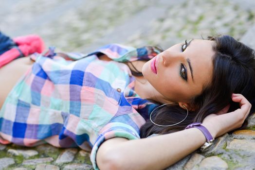 Portrait of a young beautiful woman in a urban background