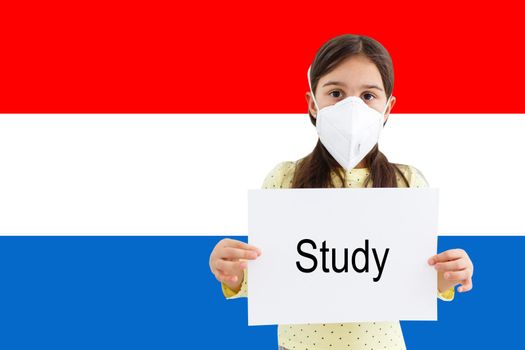 little girl in face mask holdinginscription study with Netherlands flag background. Flu epidemic and virus protection concept