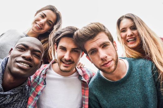 Group of multi-ethnic young people having fun together outdoors in urban background