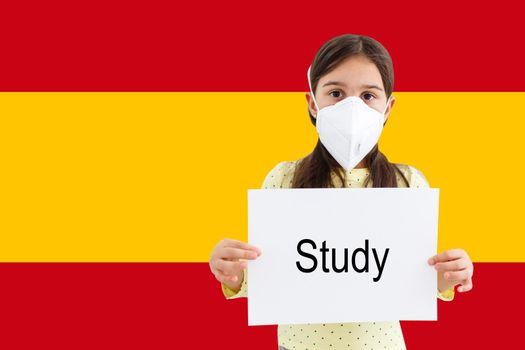 Masked little girl looking at the camera on flag Spain background. The concept of attention to the worldwide spread of the coronavirus worldwide. Coronavirus, virus in Spain.