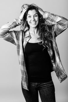 Portrait of beautiful young woman smiling, model of fashion, wearing casual clothes. Studio shot