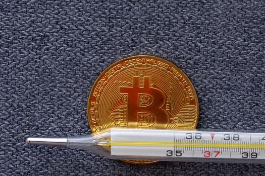 Mercury thermometer and bitcoin on white. High quality photo