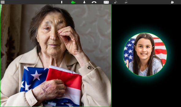 laptop monitor with video conference of people with us flag.