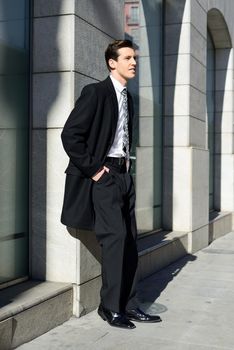Portrait of attractive young businessman in urban background